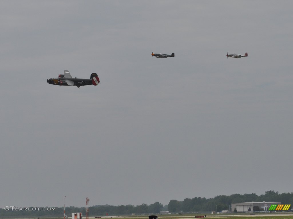 Consolidated B-24J Liberator, escorted by two North American Aviation P-51 Mustangs